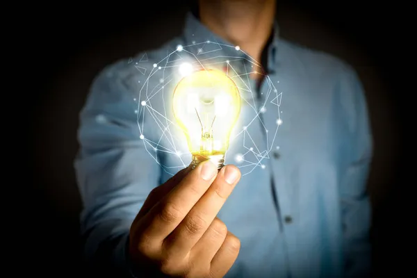 Glow Your Ideas Man Holding Light Bulb Black Background Closeup — Stock Photo, Image