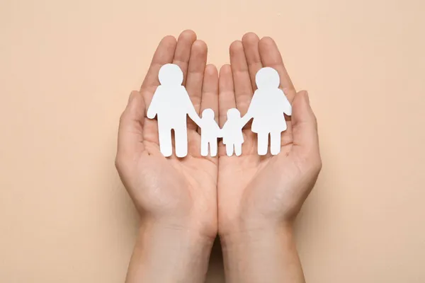 Woman Holding Paper Family Cutout Beige Background Top View — Stock Photo, Image