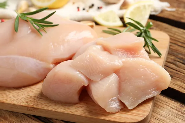 Fresh Raw Cut Chicken Breast Rosemary Wooden Table Closeup — Stock Photo, Image
