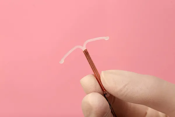 Doctor Holding Shaped Intrauterine Birth Control Device Pink Background Closeup — Stock Photo, Image