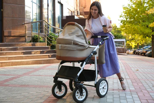 Young Mother Walking Her Baby Stroller Outdoors — Stock Photo, Image