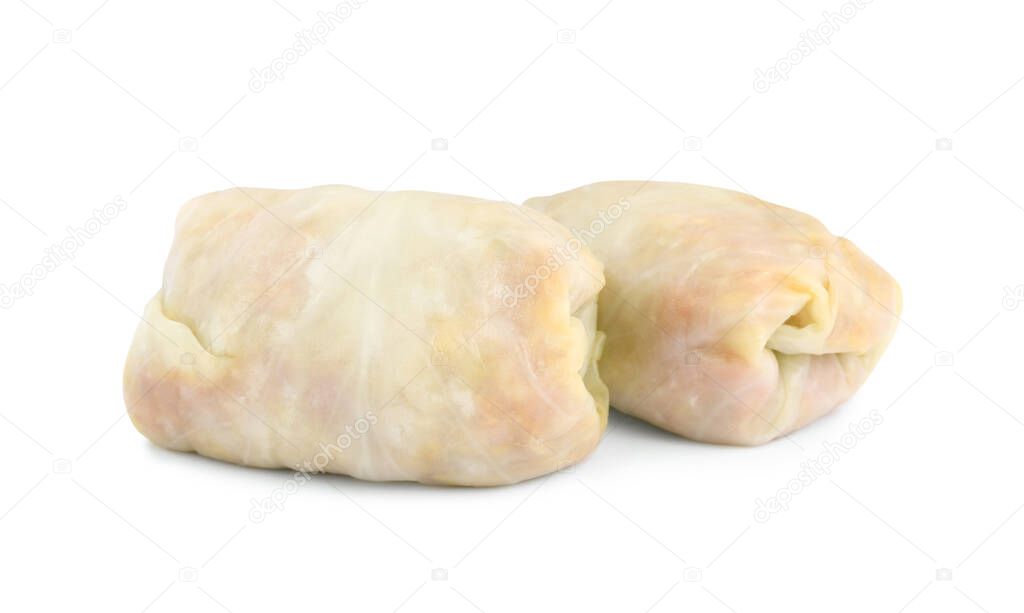 Uncooked stuffed cabbage rolls on white background
