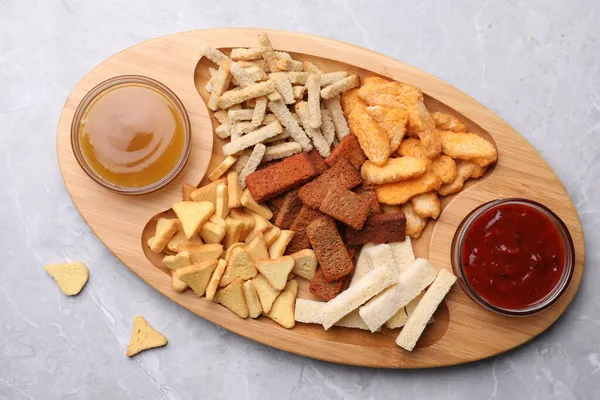 Wooden Tray Different Crispy Rusks Dip Sauces Light Marble Table — Stock Photo, Image