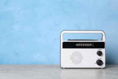 Gri masada açık mavi arkaplana karşı retro radyo alıcısı. Metin için boşluk