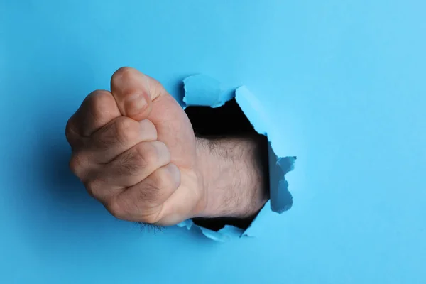 Man Breaking Light Blue Paper Fist Closeup — Stock Photo, Image