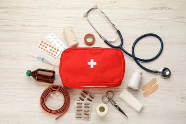 First aid kit on white wooden table, flat lay clipart