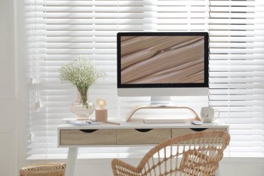 Modern bilgisayarı ve güzel çiçekleri olan rahat bir iş yeri. İç tasarım