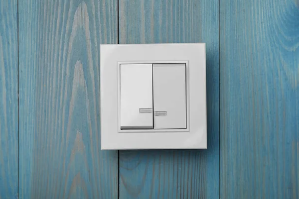 White Light Switch Turquoise Wooden Background — Stock Photo, Image