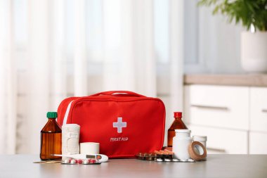 First aid kit on light grey table indoors clipart