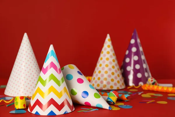 Many Colorful Party Hats Festive Items Red Background — Stock Photo, Image