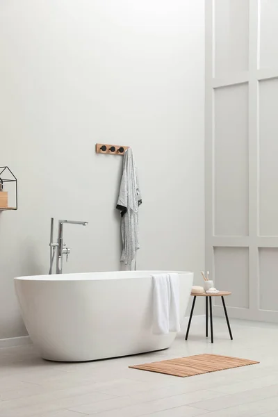 Moderna Bañera Cerámica Con Toalla Cerca Pared Blanca Habitación —  Fotos de Stock