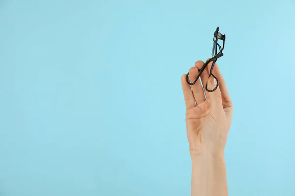 Woman Holding Eyelash Curler Light Blue Background Closeup Space Text — Stock Photo, Image