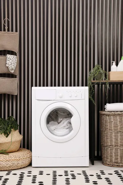 Stylish laundry room interior with washing machine