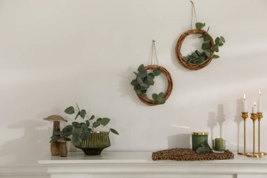 Odadaki beyaz duvarda güzel bir okaliptüs dekoru var. İç öge