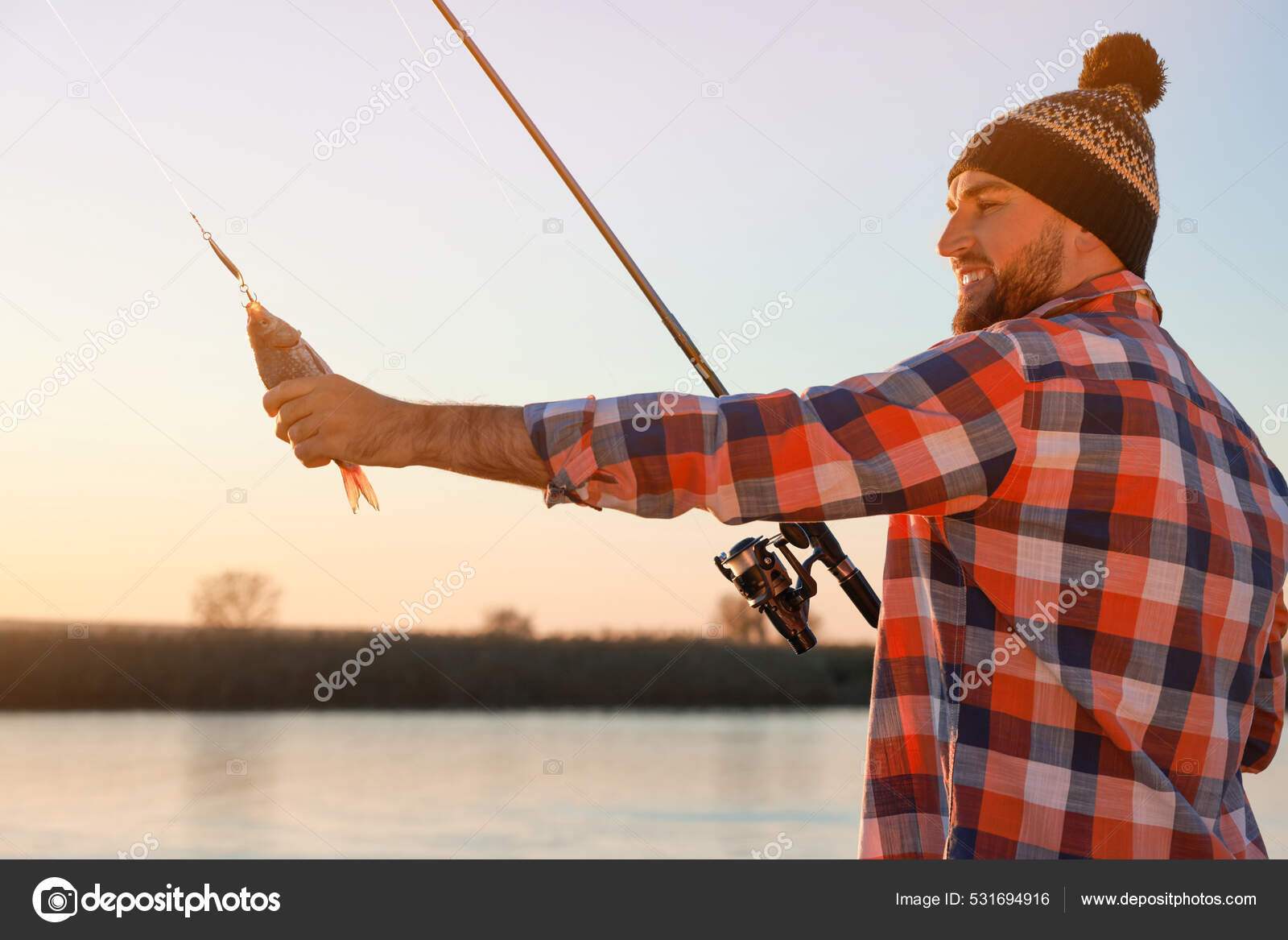 Fisherman Rod Caught Fish Riverside Stock Photo by ©NewAfrica 531694916