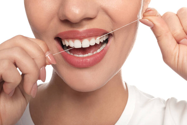 Woman flossing his teeth on white background, closeup. Dental care
