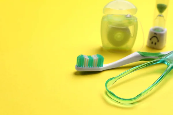 Tongue Cleaner Toothbrush Dental Floss Hourglass Yellow Background Closeup Space — Stock Photo, Image