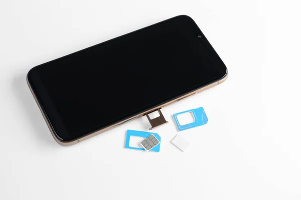Karty Sim Telefon Komórkowy Białym Stole — Zdjęcie stockowe