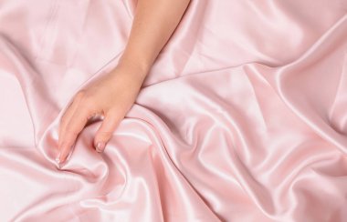 Pürüzsüz ipek kumaşa dokunan kadın, üst manzara. Boşluk veya metin