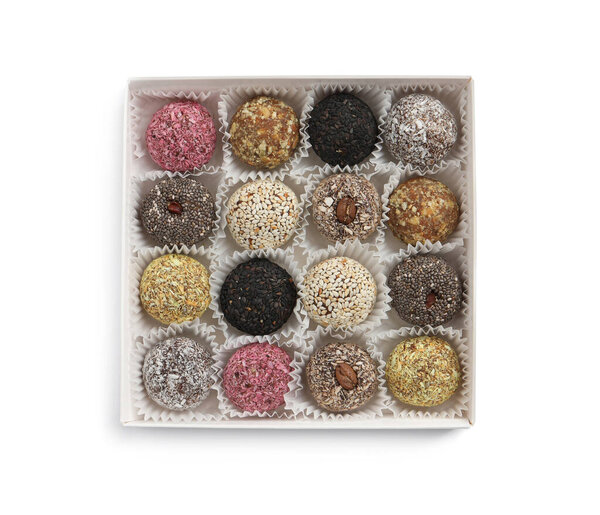 Different delicious vegan candy balls in box on white background, top view