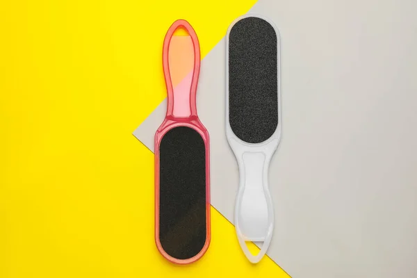 Foot files on color background, flat lay. Pedicure tools