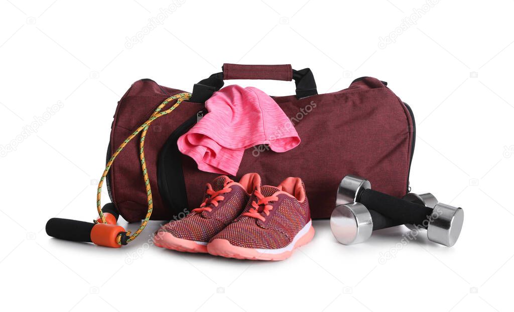 Sports bag and gym equipment on white background