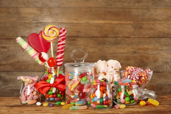 Üvegek Különböző Ízletes Cukorka Asztalon — Stock Fotó