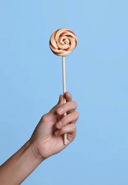 Woman Holding Bright Tasty Lollipop Light Blue Background Closeup — Stock Photo, Image