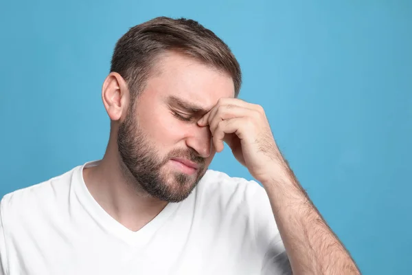 Young Man Suffering Headache Light Blue Background — Stock Photo, Image