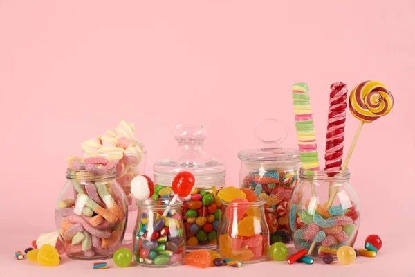 Glass Jars Lots Different Candies Pink Background — Stock Photo, Image