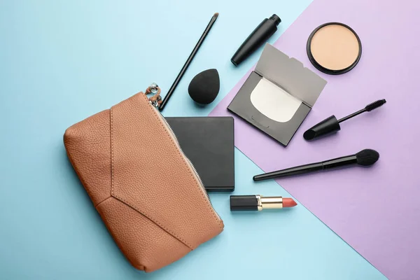 Flat lay composition with facial oil blotting tissues and makeup products on color background. Mattifying wipes