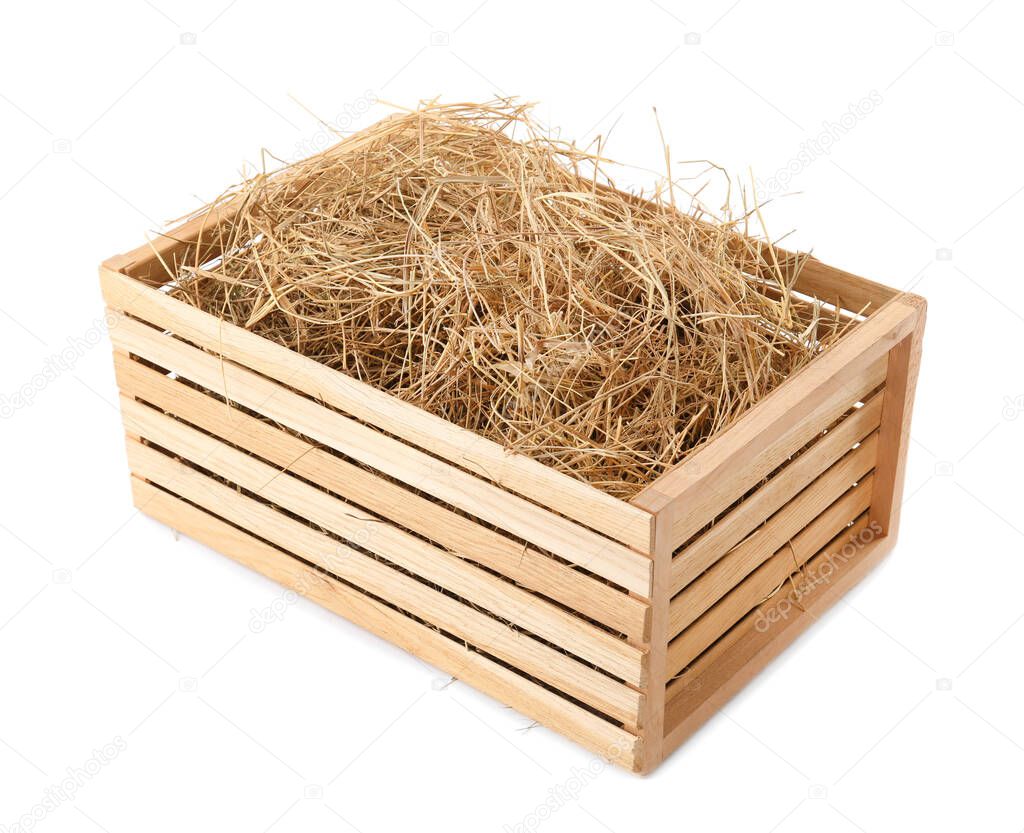 Dried hay in wooden crate on white background