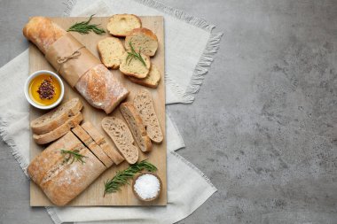 Gri masada taze ciabatta ve baget ekmeği, üst manzara. Metin için boşluk