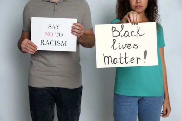 Man African American Woman Holding Signs Grey Background Closeup Racism — Stock Photo, Image