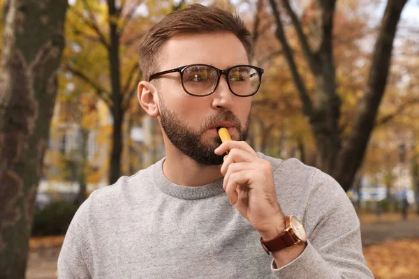 Handsome Young Man Using Disposable Electronic Cigarette Park Autumn Day — Stock Photo, Image