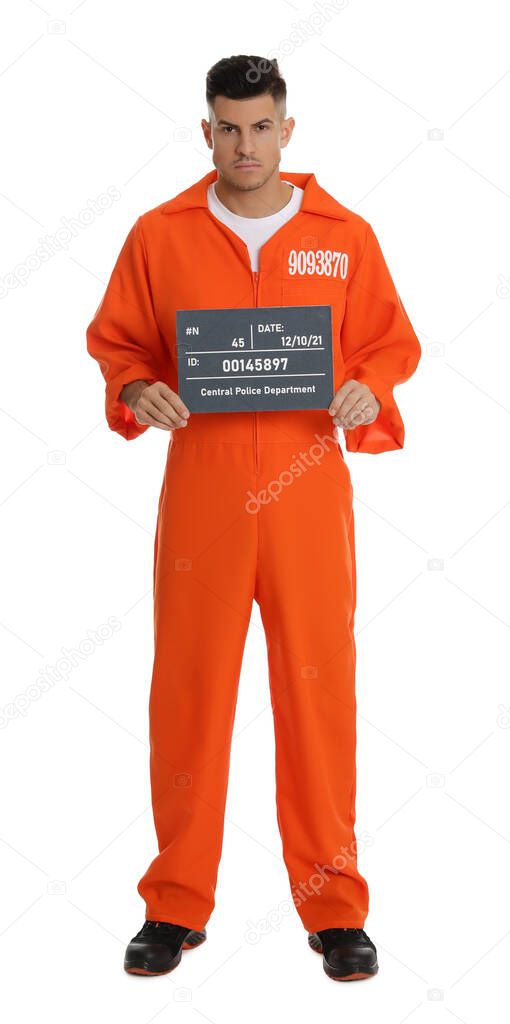 Prisoner in orange jumpsuit with mugshot letter board on white background