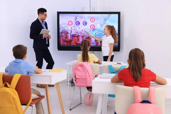 Teacher Pupil Using Interactive Board Classroom Lesson — стоковое фото