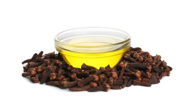 Beyaz arka planda temel yağ ve kurutulmuş karanfiller