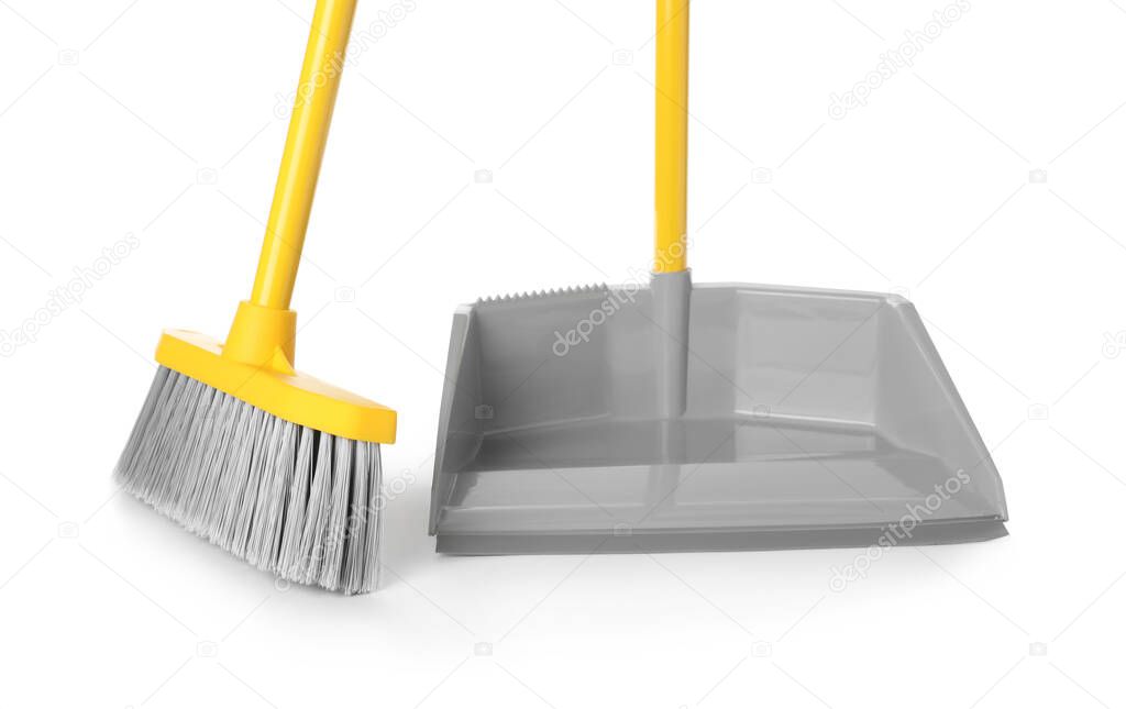 Plastic broom and dustpan on white background