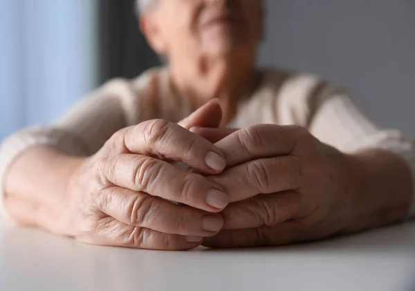 Elderly Woman White Table Indoors Closeup — Stock Photo, Image