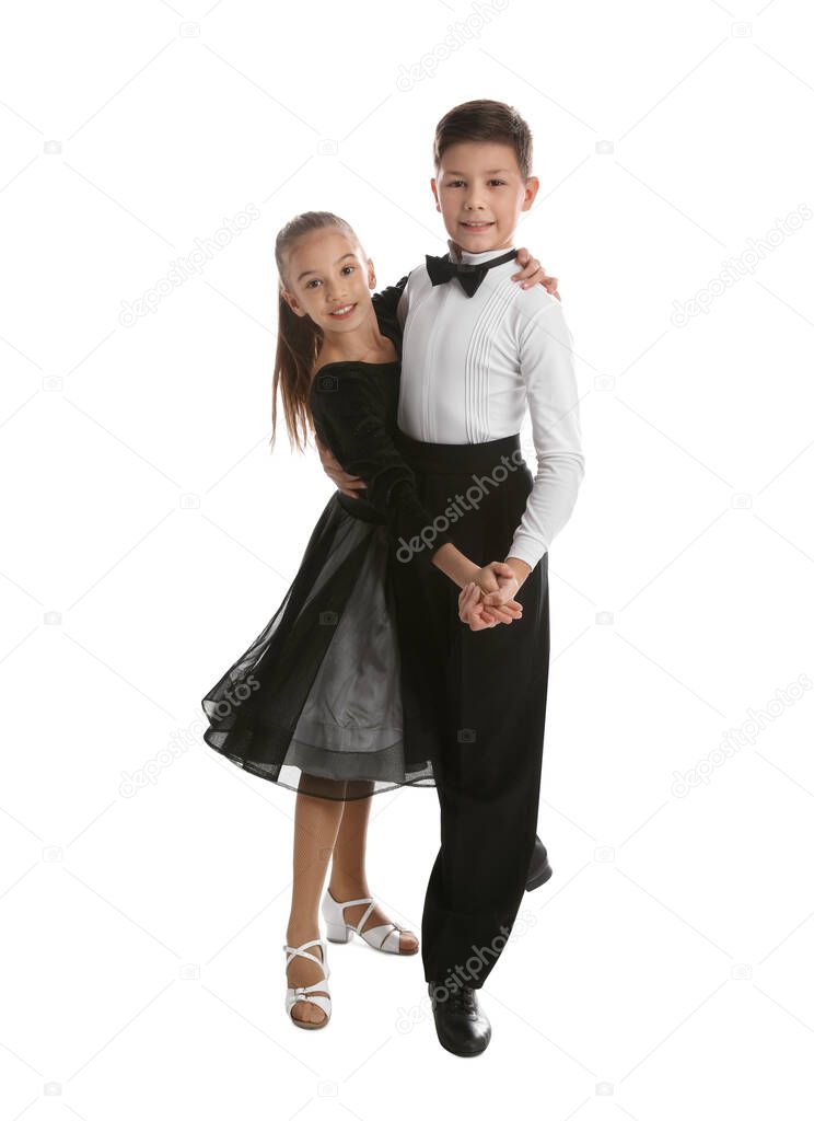 Beautifully dressed couple of kids dancing on white background