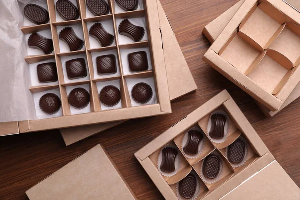 Many Delicious Chocolate Candies Boxes Wooden Table Flat Lay Production — Stock Photo, Image