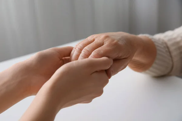 Young Elderly Women Holding Hands Together White Table Indoors Closeup — Stock Photo, Image