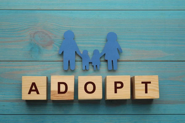 Family Figure Word Adopt Made Cubes Light Blue Wooden Table — Stockfoto