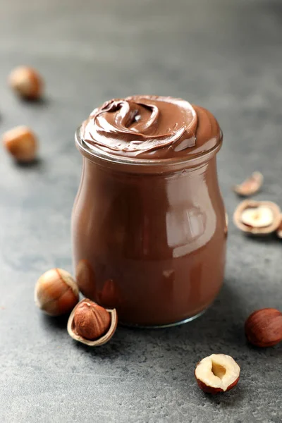 Glass Jar Tasty Chocolate Hazelnut Spread Nuts Grey Table — 图库照片