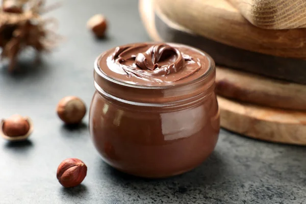 Glass Jar Tasty Chocolate Hazelnut Spread Nuts Grey Table — 图库照片