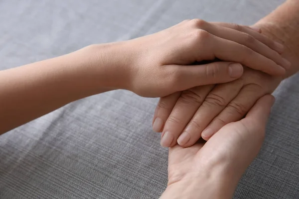 Young Elderly Women Holding Hands Together Grey Fabric Closeup — Stock Photo, Image