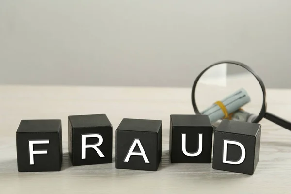 Black Cubes Word Fraud Magnifying Glass Money White Table Space — Stock Photo, Image