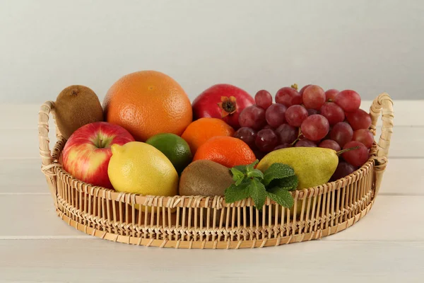 Fresh Ripe Fruits Wicker Tray White Wooden Table — Stockfoto