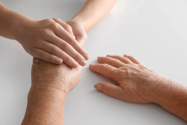 Young Elderly Women Holding Hands Together White Table Closeup — Stock Photo, Image